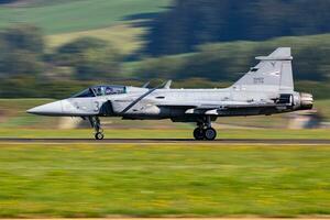 Hungarian Air Force SAAB JAS 39 Gripen. Military fighter jet plane at air base. Flight operation. Aviation and aircraft. Air defense. Fly and flying. photo