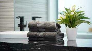 Black towels on marble desk in the foreground and blurred modern bathroom photo