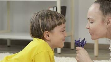 a woman and a child are laying on the floor with lavender flowers video