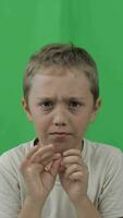 a boy is making a face on a green screen video