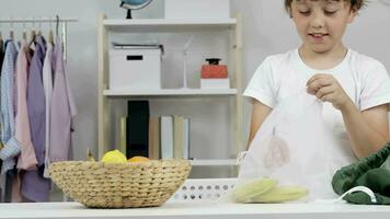 a young boy is holding a bag of fruit video