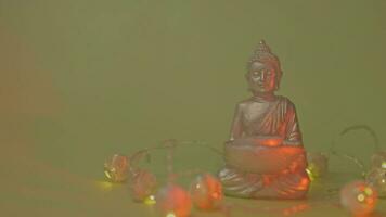 a buddha statue is surrounded by lights video