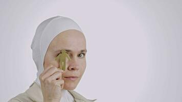 a woman in a white hijab holding a small object video