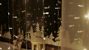 a window with lights and a christmas tree video