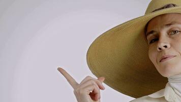 a woman wearing a large hat pointing her finger video