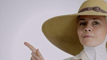 uma mulher vestindo uma ampla chapéu apontando dela dedo video