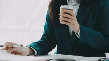 Businesswoman using calculators for do math finance on wooden desks in office and business working background, tax, accounting, statistics, and analytic research concept video