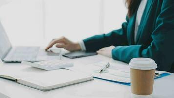 Businesswoman using calculators for do math finance on wooden desks in office and business working background, tax, accounting, statistics, and analytic research concept video