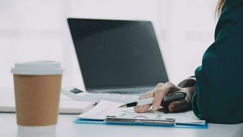 Businesswoman using calculators for do math finance on wooden desks in office and business working background, tax, accounting, statistics, and analytic research concept video