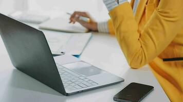 Businesswoman using calculators for do math finance on wooden desks in office and business working background, tax, accounting, statistics, and analytic research concept video