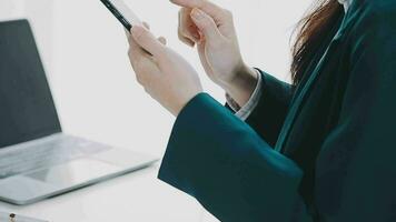 Businesswoman using calculators for do math finance on wooden desks in office and business working background, tax, accounting, statistics, and analytic research concept video