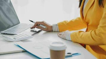 Businesswoman using calculators for do math finance on wooden desks in office and business working background, tax, accounting, statistics, and analytic research concept video