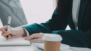 Businesswoman using calculators for do math finance on wooden desks in office and business working background, tax, accounting, statistics, and analytic research concept video