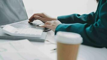 Businesswoman using calculators for do math finance on wooden desks in office and business working background, tax, accounting, statistics, and analytic research concept video
