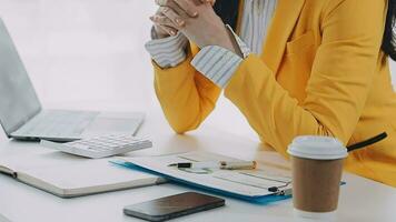 Businesswoman using calculators for do math finance on wooden desks in office and business working background, tax, accounting, statistics, and analytic research concept video