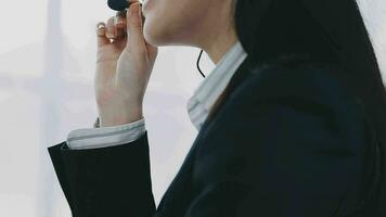 Service phone operators sit at shared desk focus on sales agent woman in headset use pc answers incoming calls talk with client provide professional support to customers sell company product concept video