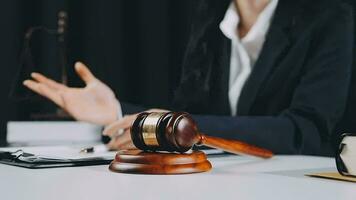 Business and lawyers discussing contract papers with brass scale on desk in office. Law, legal services, advice, justice and law concept picture with film grain effect video