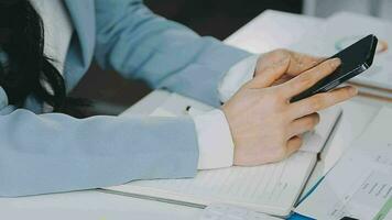 Young asian business woman working on project plan using sticky papers notes on glass wall, people meeting to share idea, Business design planning concepts. video