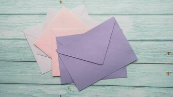 colorful envelope on pink background with copy space. video
