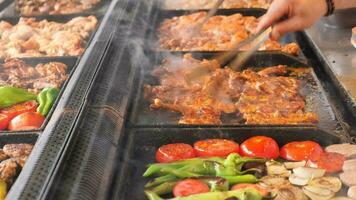 Beef and chicken steaks on the grill with flames. video