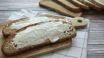 cheese cream spread on brown bread on table video