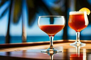 two glasses of red liquid sitting on a table near the ocean. AI-Generated photo