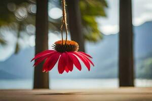 a red flower hanging from a string. AI-Generated photo