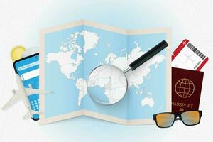 Travel destination Cameroon, tourism mockup with travel equipment and world map with magnifying glass on a Cameroon. vector