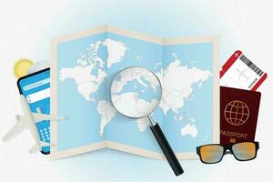 Travel destination Tunisia, tourism mockup with travel equipment and world map with magnifying glass on a Tunisia. vector