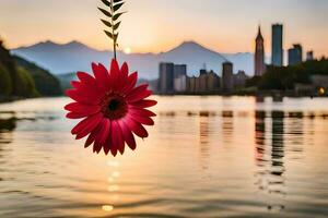 a red flower hanging from a branch over a body of water. AI-Generated photo