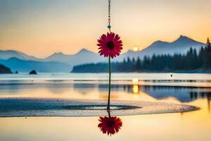a pink flower is hanging from a chain over a lake. AI-Generated photo