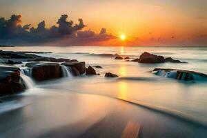 un hermosa puesta de sol terminado el Oceano con rocas y agua. generado por ai foto