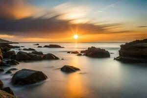 un puesta de sol terminado el Oceano con rocas y agua. generado por ai foto