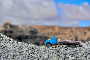 a toy truck is parked on a rocky hill photo