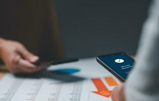businessperson's hand holds a smartphone on screen with the message money received. Concept of financial transactions with mobile devices. Closeup, money, transfer, phone, payment. blurred background photo