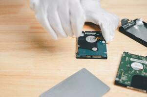 fix and repair hard drive computer for recovery data and backup to storage new concept. hand of engineer holding hard drive or disk for repair, fix Bad Sector on disk. HDD or hard drive has Bad Sector photo
