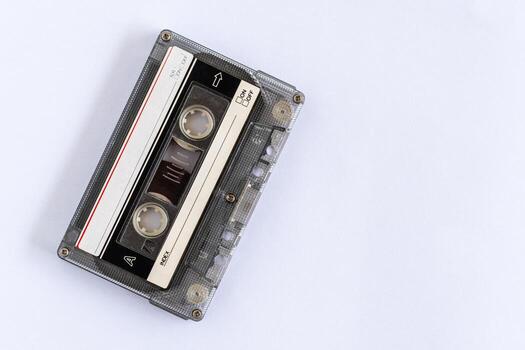 old classic tape which is technology from the 90s, used for recording music or sounds, placed on a white table, close-up, selective focused, white background. copy space on right for design or text. photo