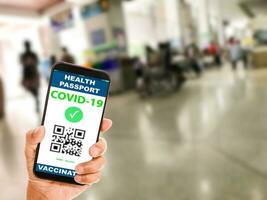 A man holding a smartphone to show vaccine passport vaccination against coronavirus or COVID-19. The concept for preventing the spread of coronavirus. and safety demonstrations after vaccination. photo