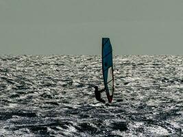 Person windsurfing in the ocean photo