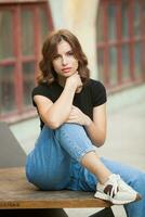 Portrait of a beautiful young woman with long brown hair smiling at the camera photo