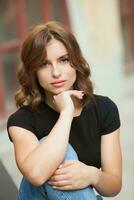 Portrait of a beautiful young woman with long brown hair smiling at the camera photo