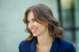 Portrait of a beautiful young woman with long brown hair smiling at the camera photo