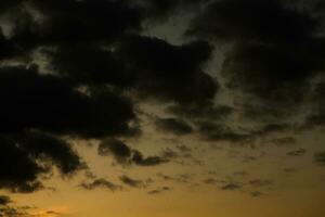 Stormy sky with dark clouds. Natural background. Sky background. Cloudscape, Colored Sunset. photo