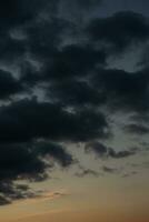 Stormy sky with dark clouds. Natural background. Sky background. Cloudscape, Colored Sunset. photo