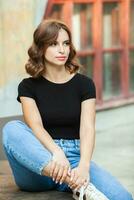 Portrait of a beautiful young woman with long brown hair smiling at the camera photo