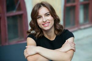 Close up portrait of a beautiful young woman smiling and looking at camera. White European girl with beautiful smile photo