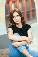 Portrait of a beautiful young woman with long brown hair smiling at the camera photo