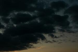 Stormy sky with dark clouds. Natural background. Sky background. Cloudscape, Colored Sunset. photo