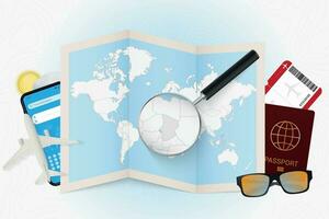 Travel destination Chad, tourism mockup with travel equipment and world map with magnifying glass on a Chad. vector