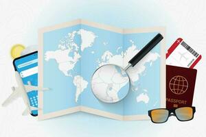 Travel destination Uganda, tourism mockup with travel equipment and world map with magnifying glass on a Uganda. vector